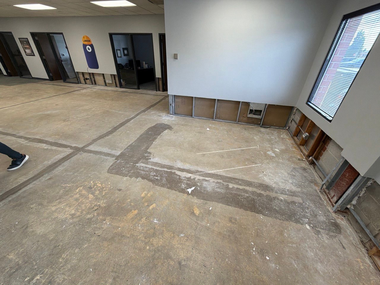 Exposed lower wall framing before drywall repair at a commercial property in Willowbrook, IL