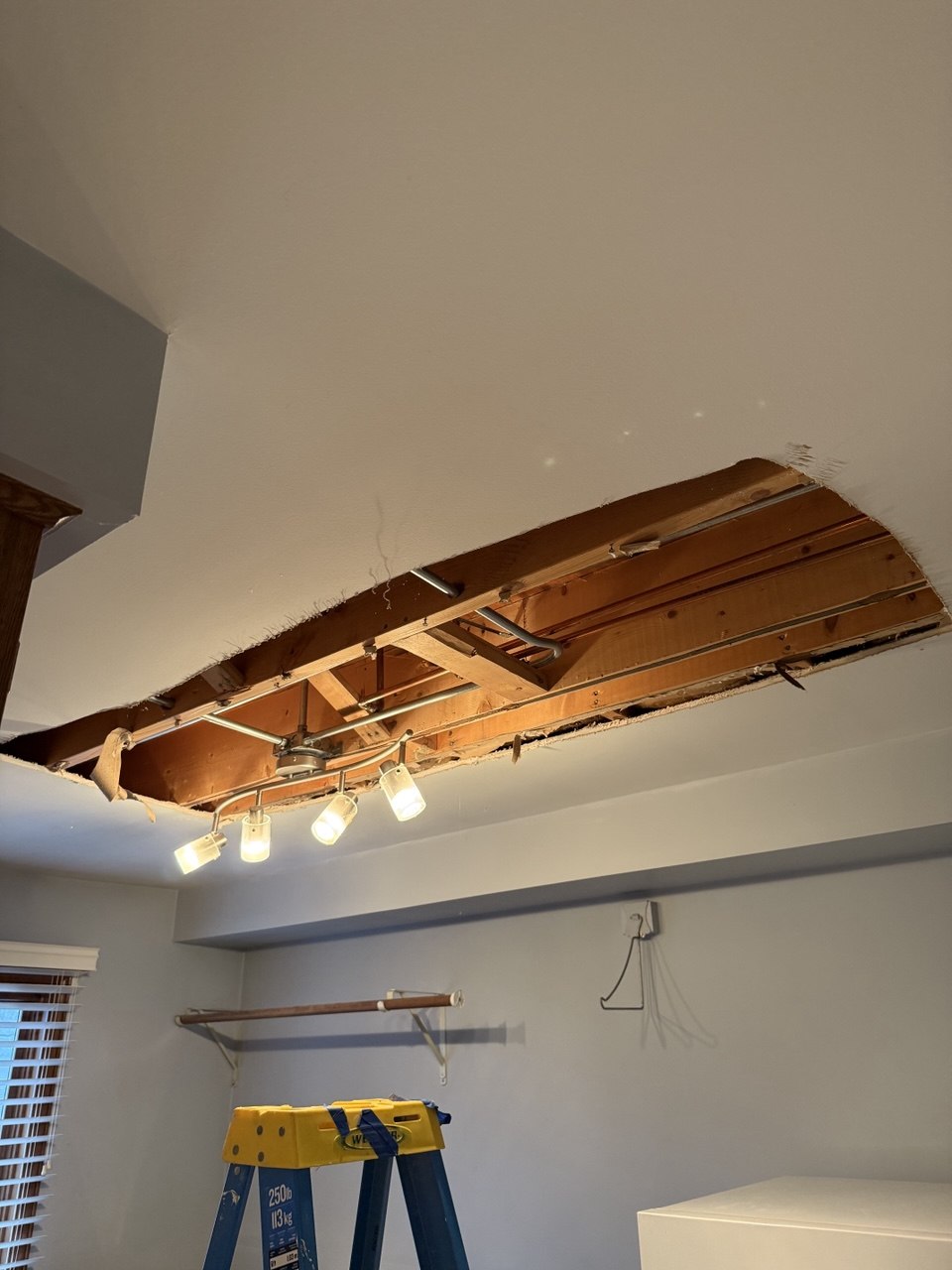 Laundry room ceiling opened for drywall repair and access in Naperville, IL