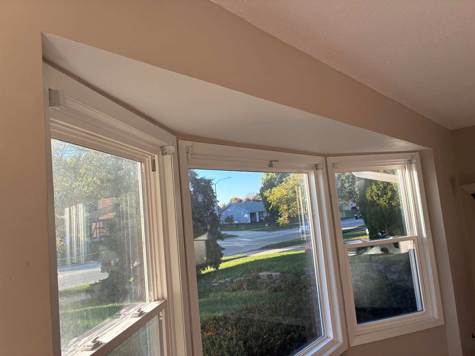 Smooth white enclosed soffit above bay windows after repair in Bolingbrook, IL