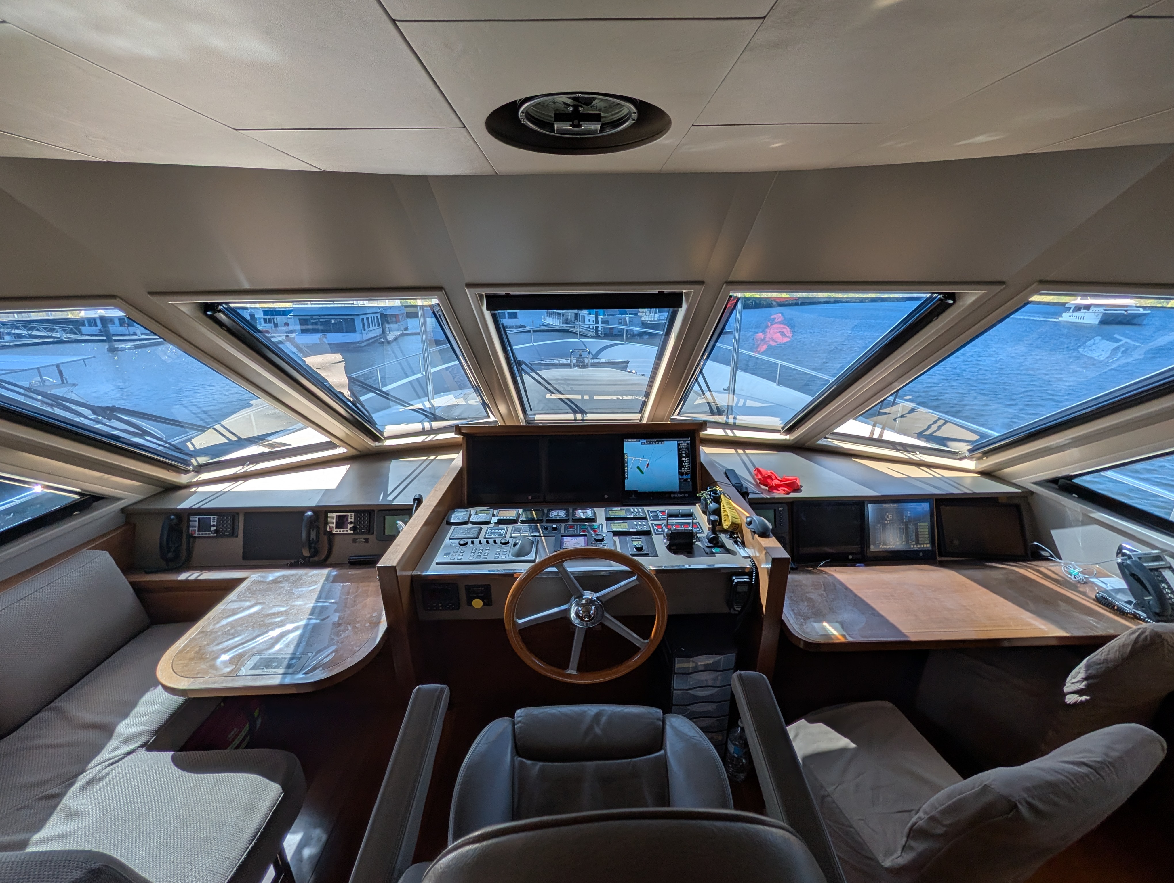 Reflective solar blind fitted to the angled cabin windows of a boat