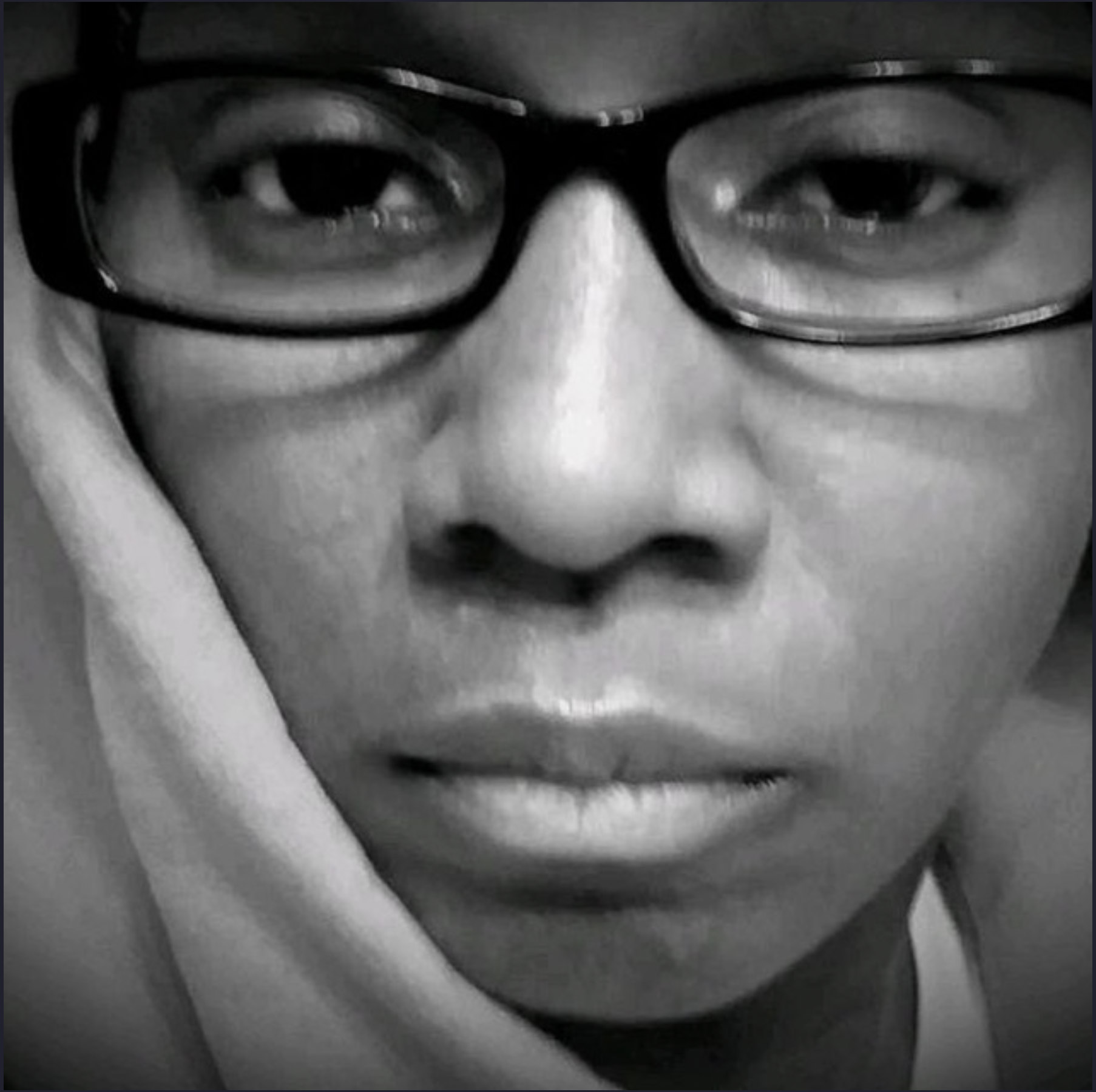 Close-up black and white portrait of a person wearing glasses resting their face on their hand.