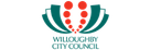 BARBADOS TOURISM logo featuring a stylized green and red design resembling a flower or palm frond.