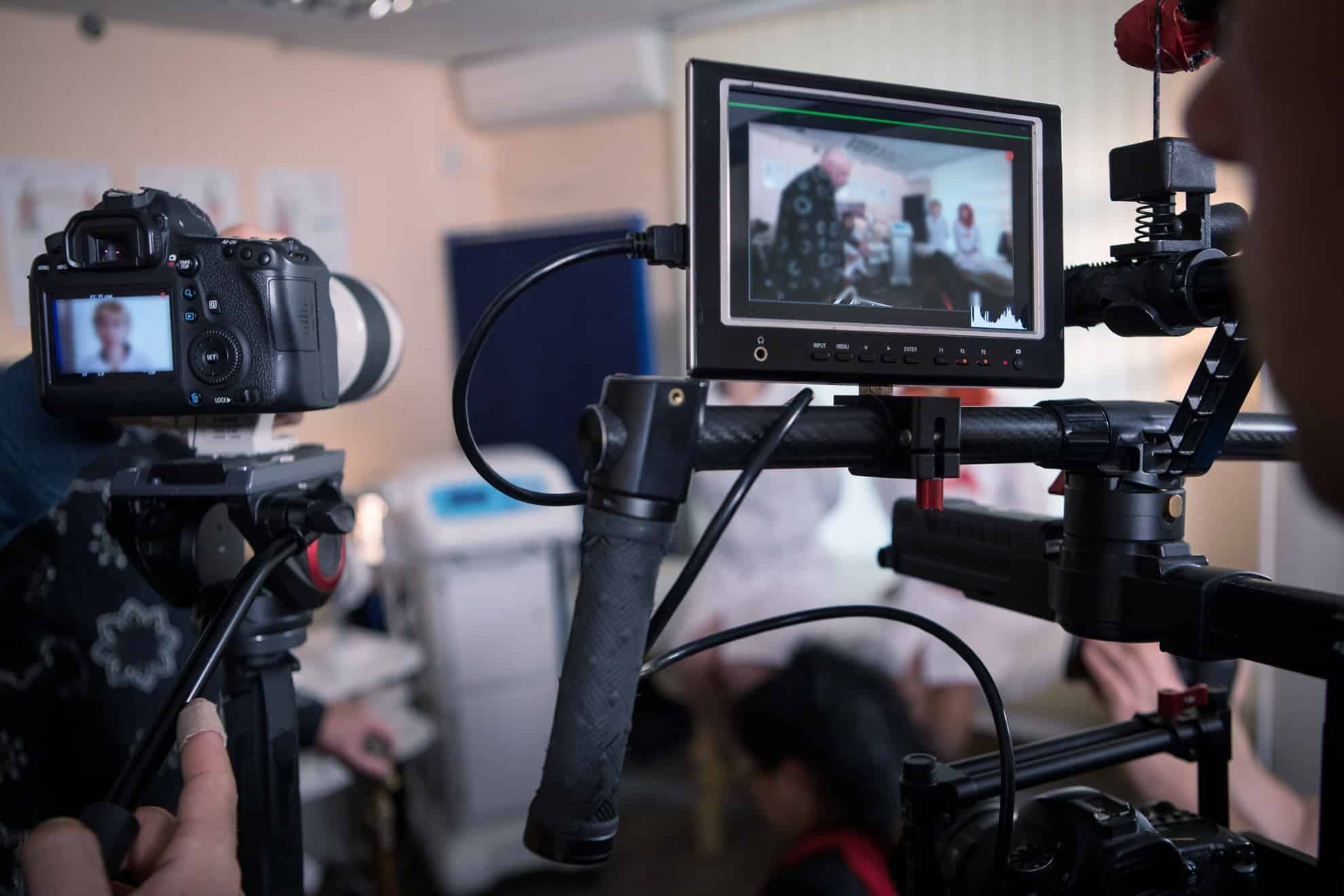 Video cameras on the set, backstage of the movie scene, operator hands