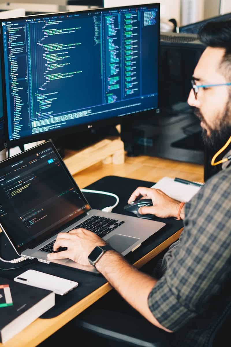 Man sitting at computer working on code