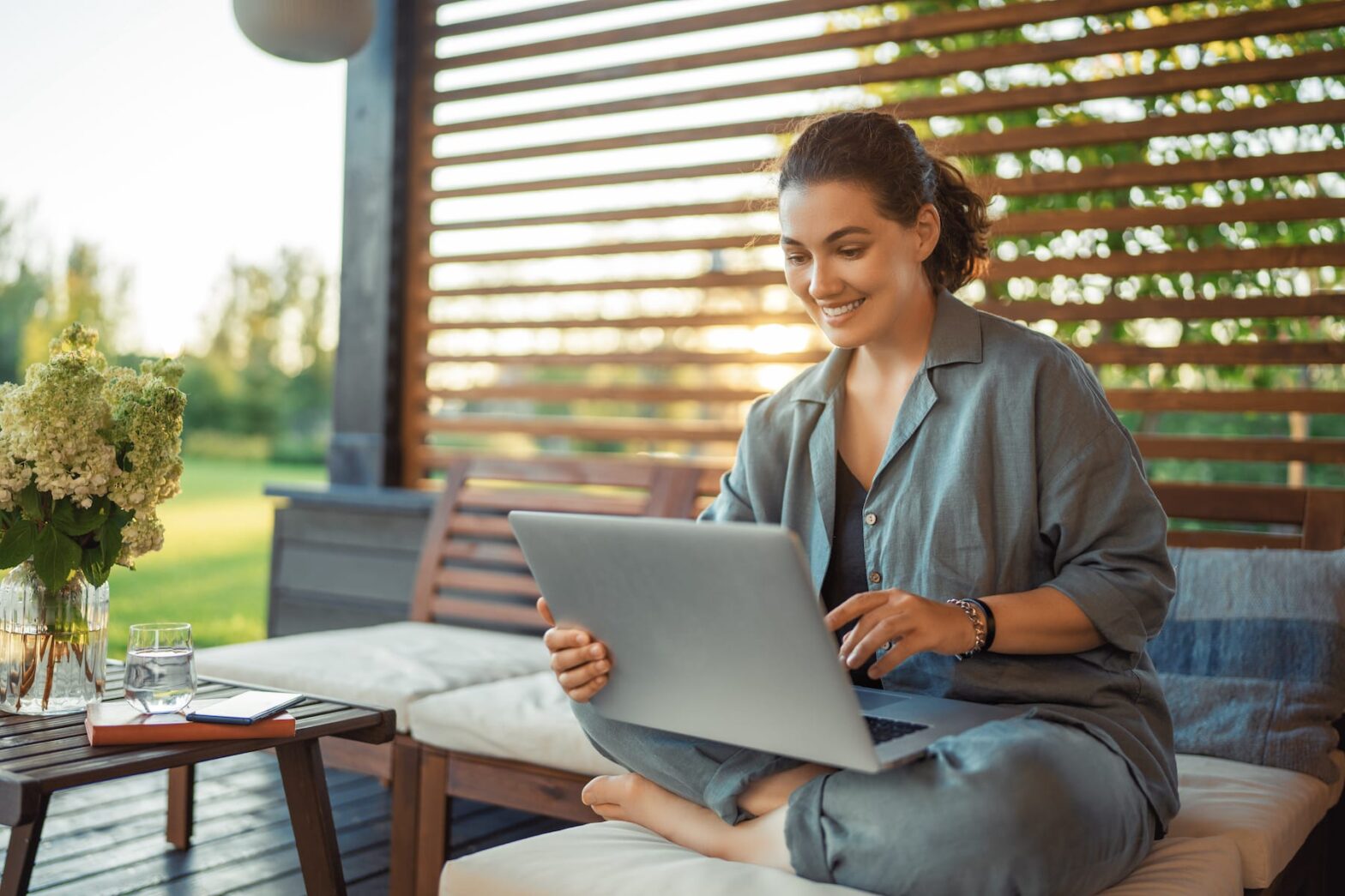 Woman sitting outside working on her laptop