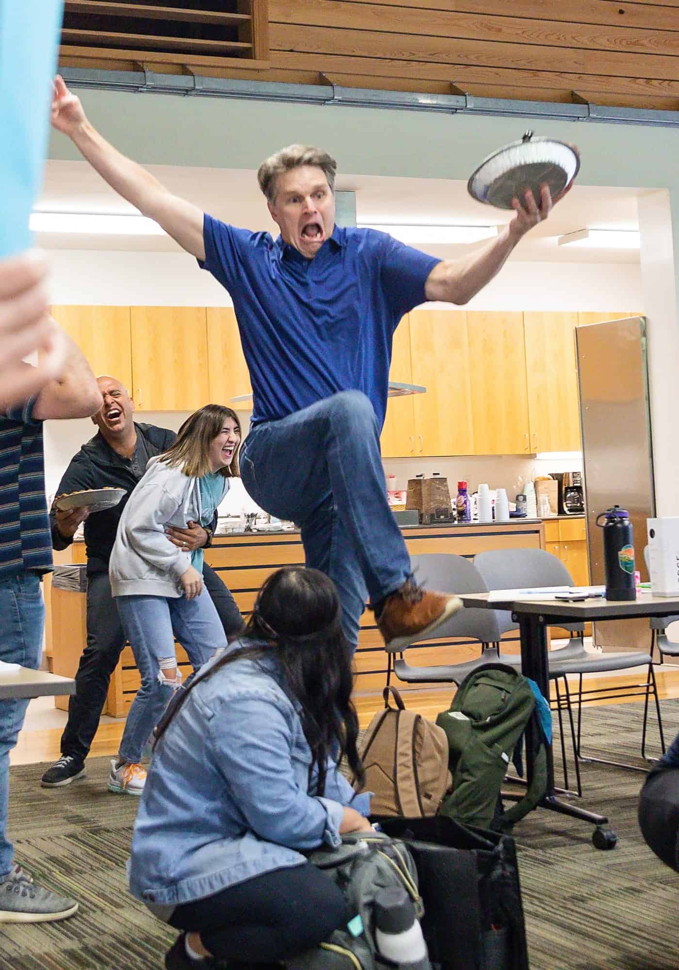 Man jumping over people with plate in his hand