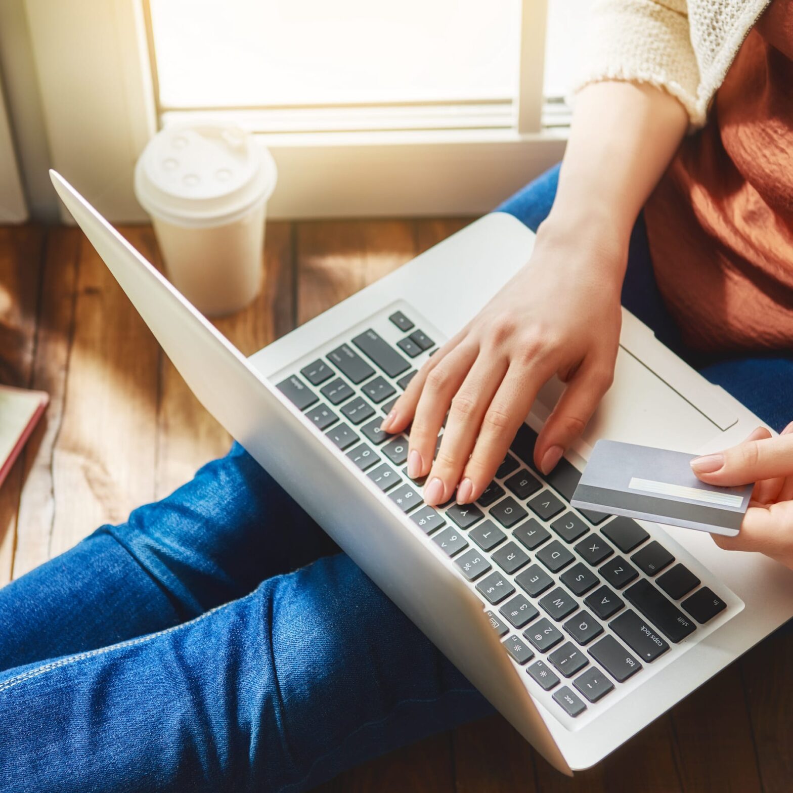 Woman online shopping sitting on the floor