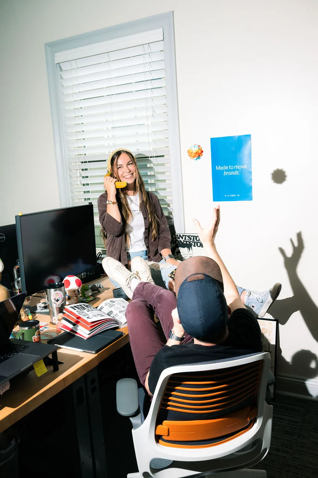 Two MESH employees and one talking on a banana phone