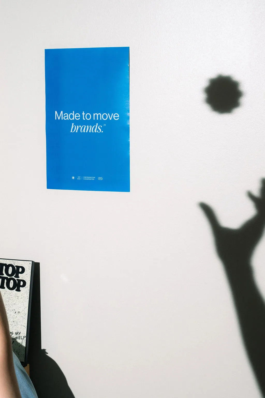 A MESH poster on the wall with a silhouette of a hand