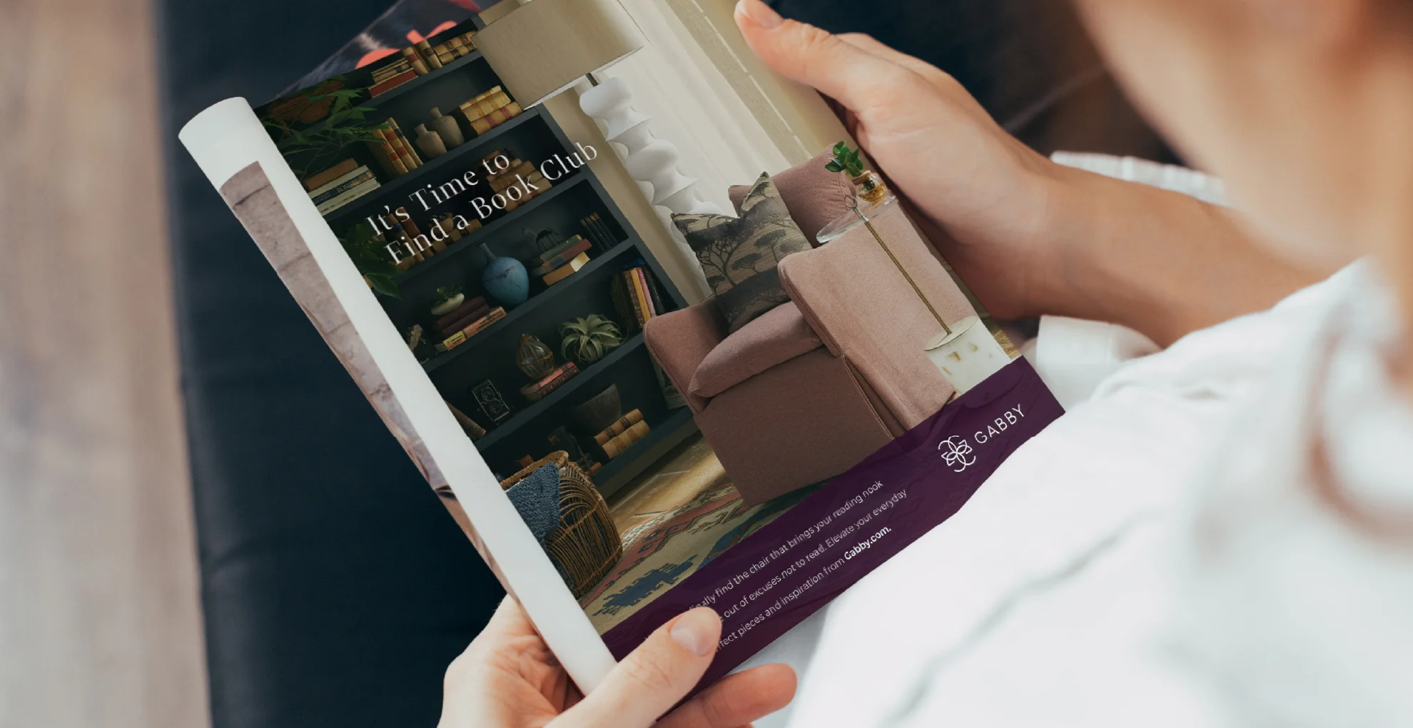 Man holding a magazine showing the Gabby print ad