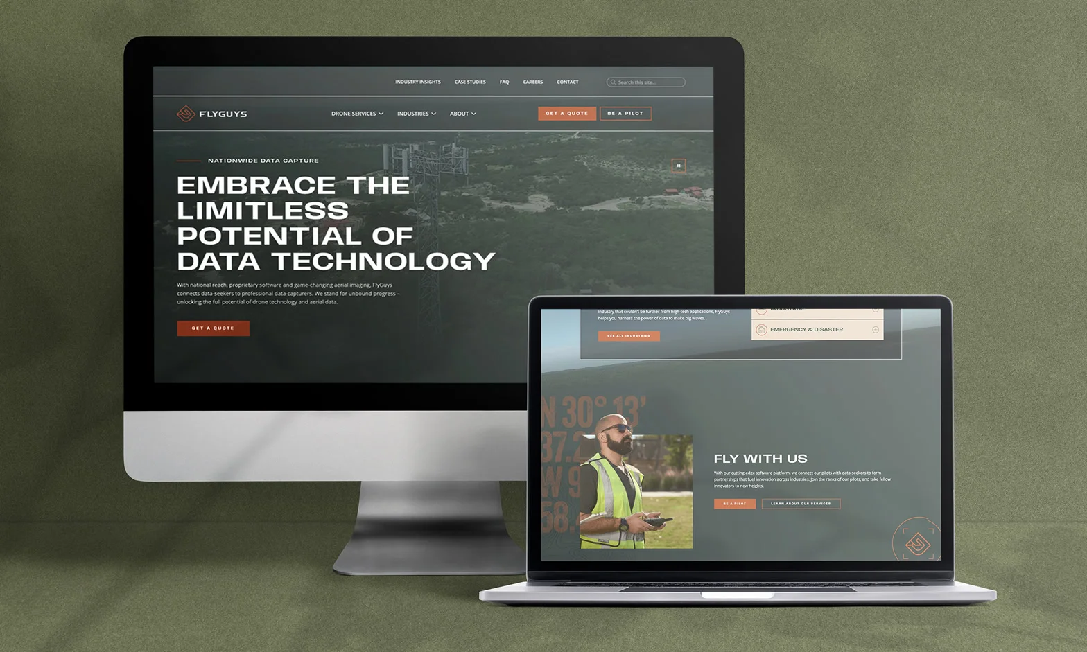 A desktop and laptop with the FlyGuys website loaded