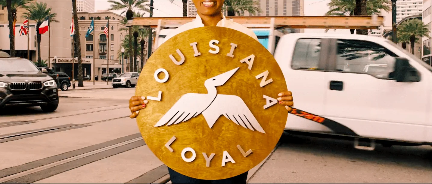 Person holding a Louisiana Loyal sign
