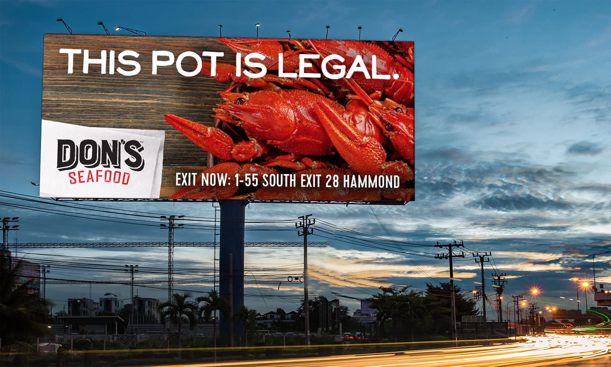 Billboard with Don's logo and crawfish with the headline "This pot is legal"