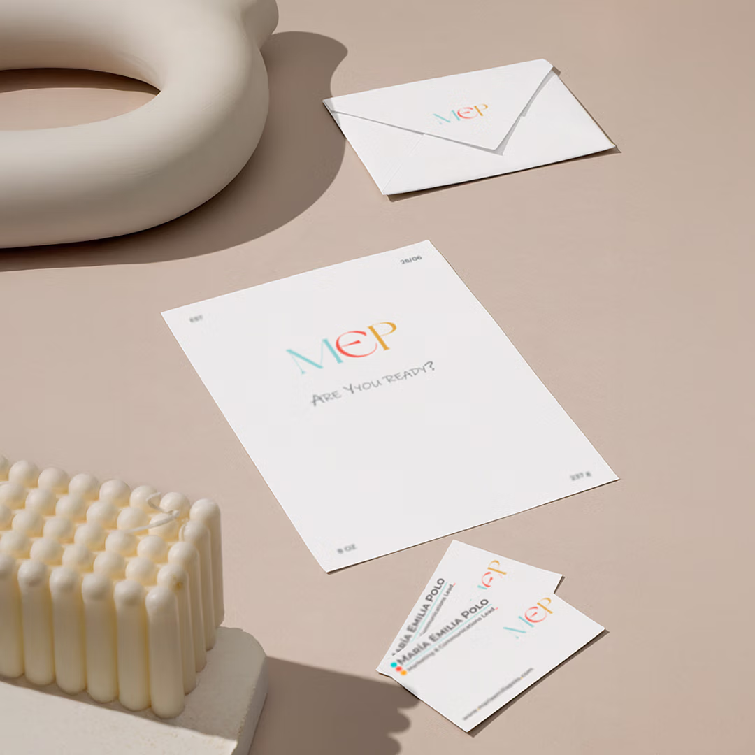 Stationery set on beige surface including an envelope, a letter with 'MEP Are You Ready?' text, and two business cards with colorful MEP logo.