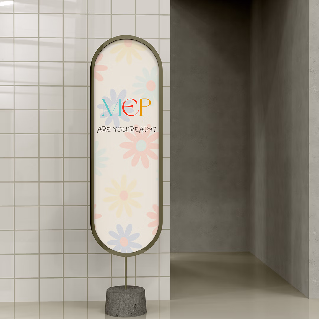 Decorative standing sign with colorful letters 'MEP' and text 'ARE YOU READY?' against a tiled wall.