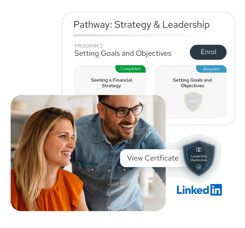 Smiling man and woman looking at a screen together with a digital display showing a Strategy & Leadership program and a LinkedIn Leadership Masterclass badge.