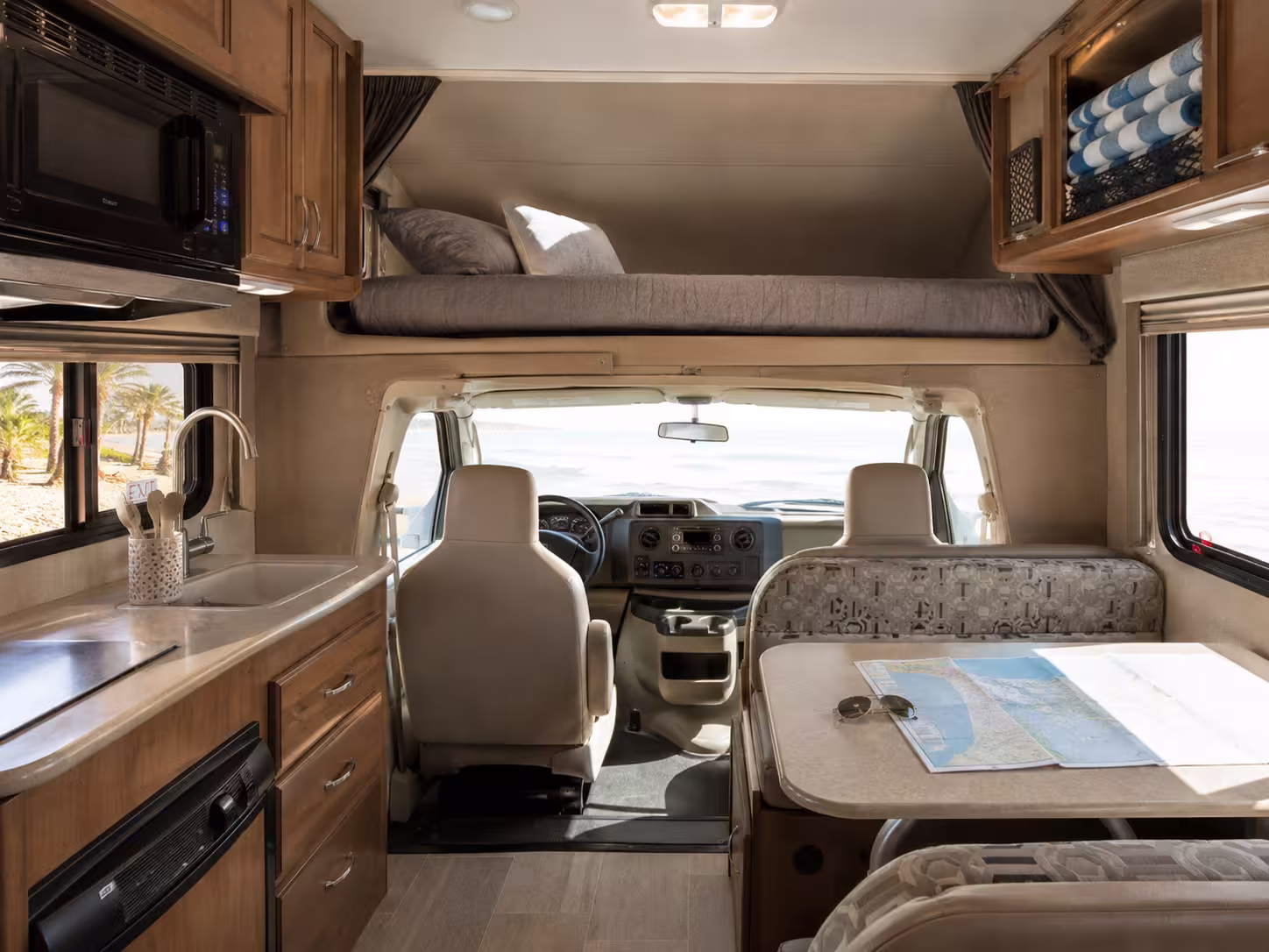 Class C motorhome interior with cab-over bunk and dinette