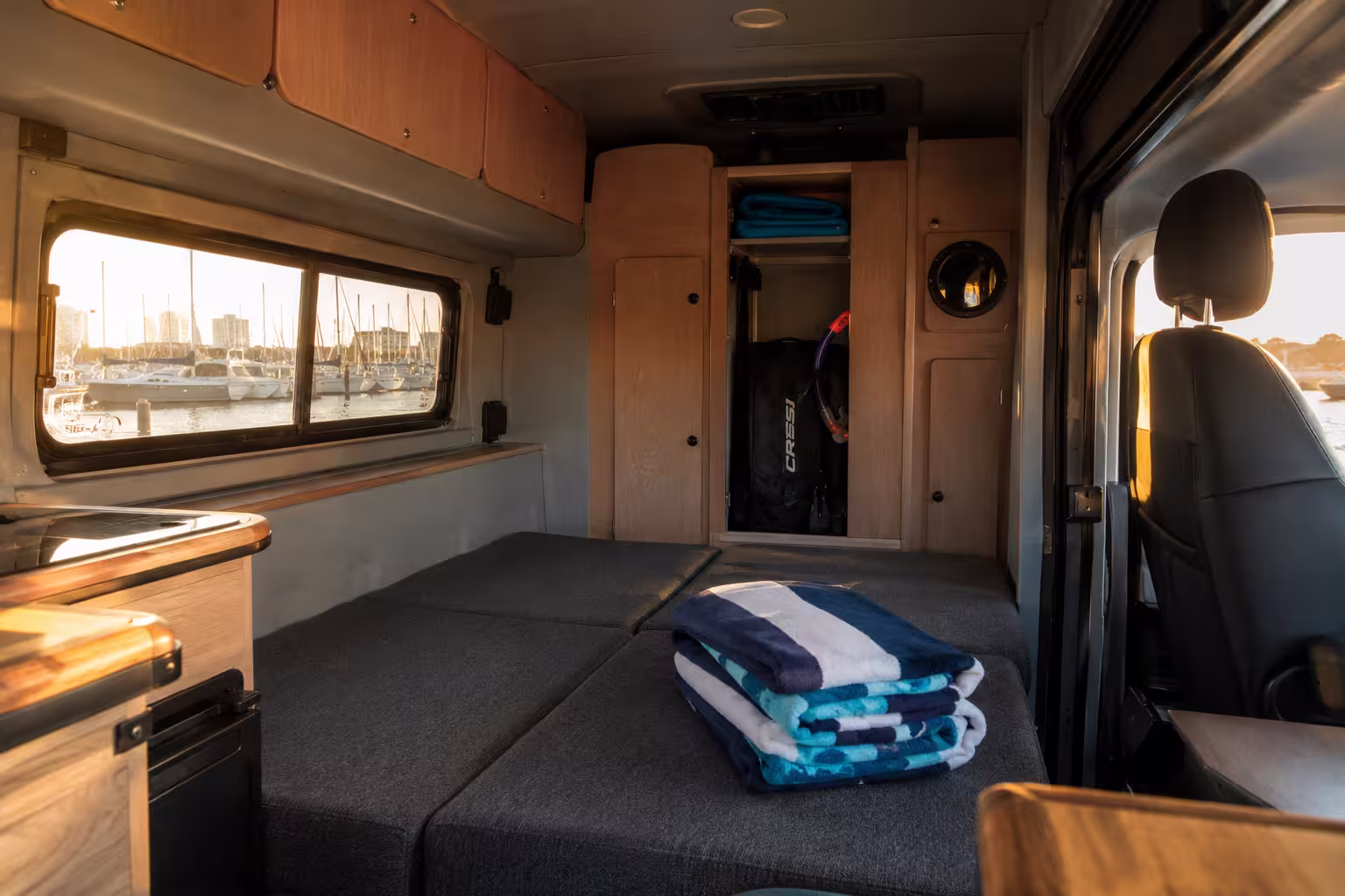 Camper van rental interior with converted dinette bed in Ft. Lauderdale