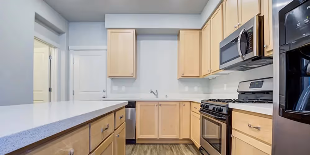 Kitchen with brown cabinets and stainless steel appliances