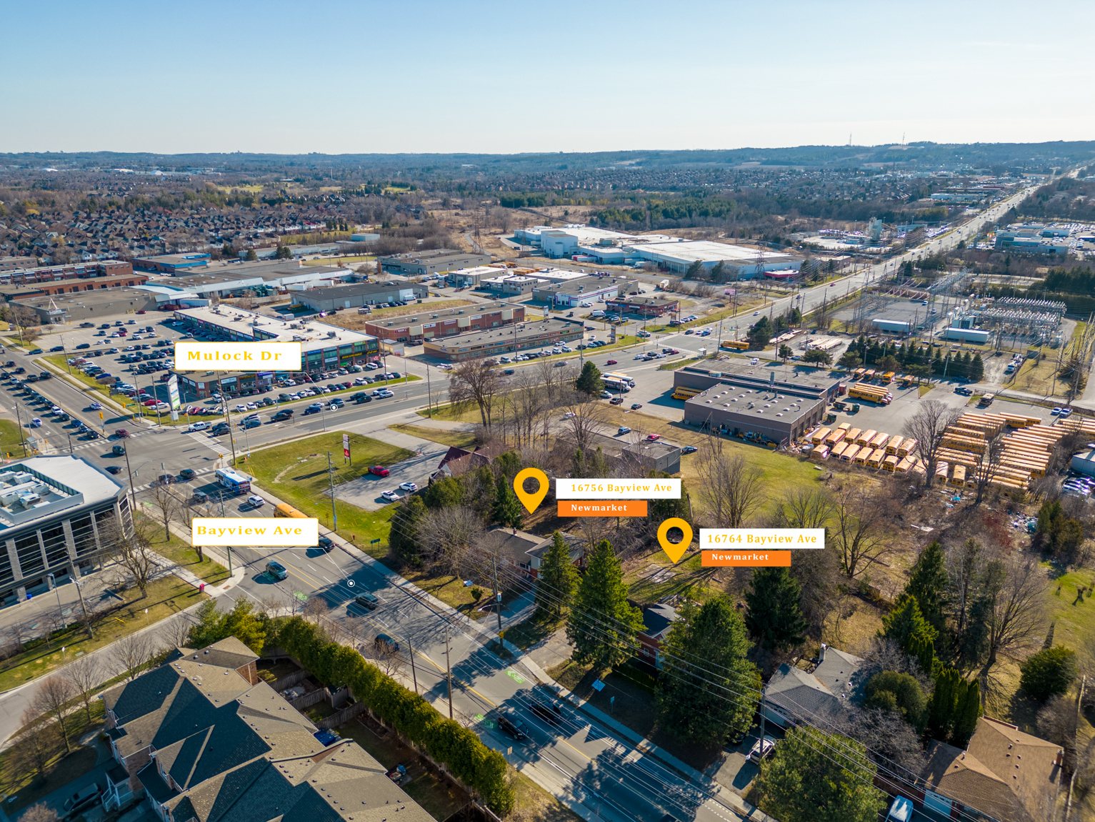 Aerial over 16756 and 16764 Bayview Avenue looking north-east, both parcels pinned, with the Mulock Drive commercial node and the Highway 404 corridor beyond.