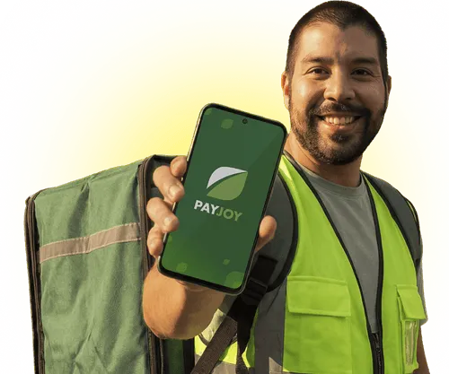 Smiling delivery man in yellow vest holds phone showing the PayJoy app logo on screen.