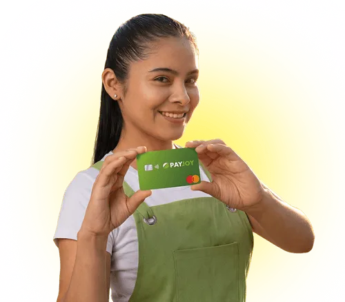 Smiling woman in green apron holding a green PayJoy Mastercard credit card against a yellow background.