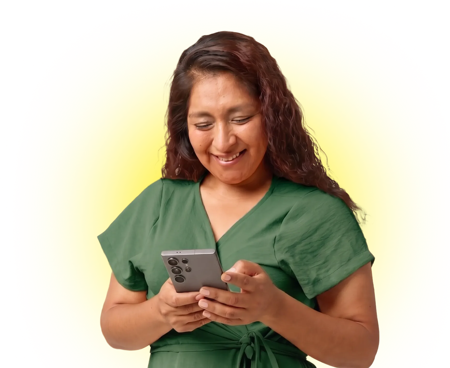 Smiling woman in green dress using smartphone against bright yellow background.