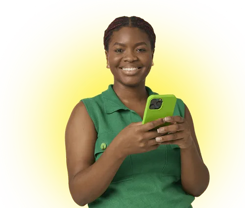 Smiling woman in green sleeveless top holding a green smartphone against a yellow background.