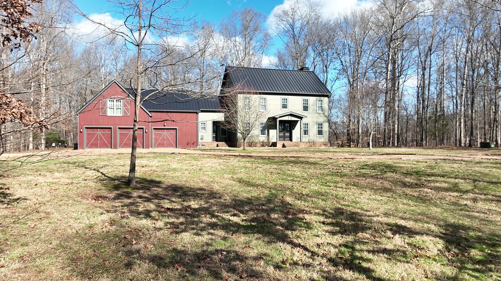 Dark bronze standing seam panels and ridge line on a farmhouse roof in Columbia, TN