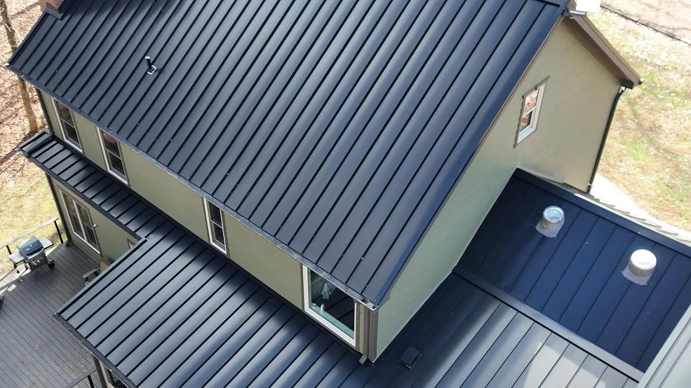 Dark bronze standing seam metal roof against mature trees in Columbia, TN