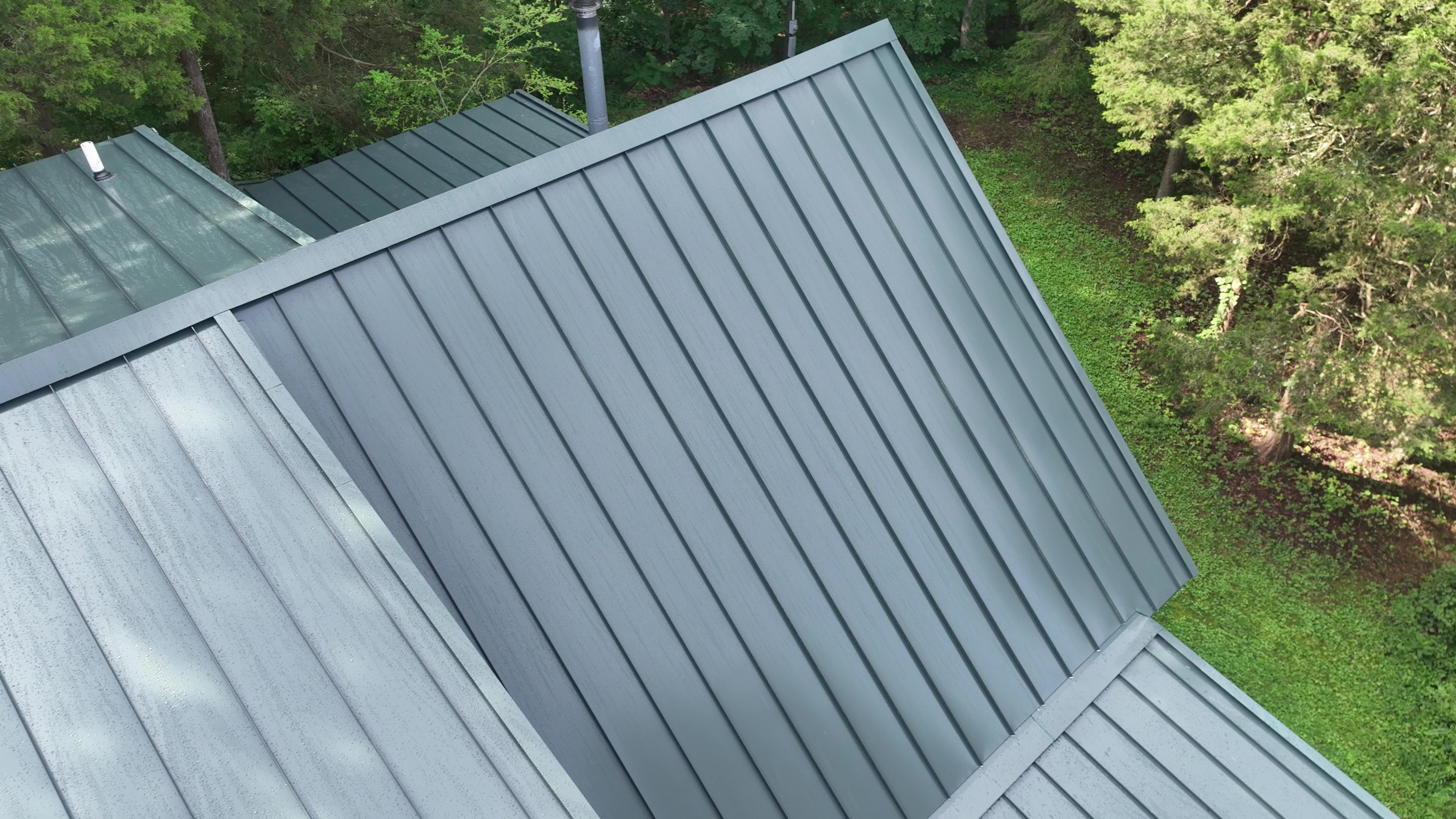 Elevated view of a Hartford Green standing seam metal roof on a log cabin home in Cookeville, TN
