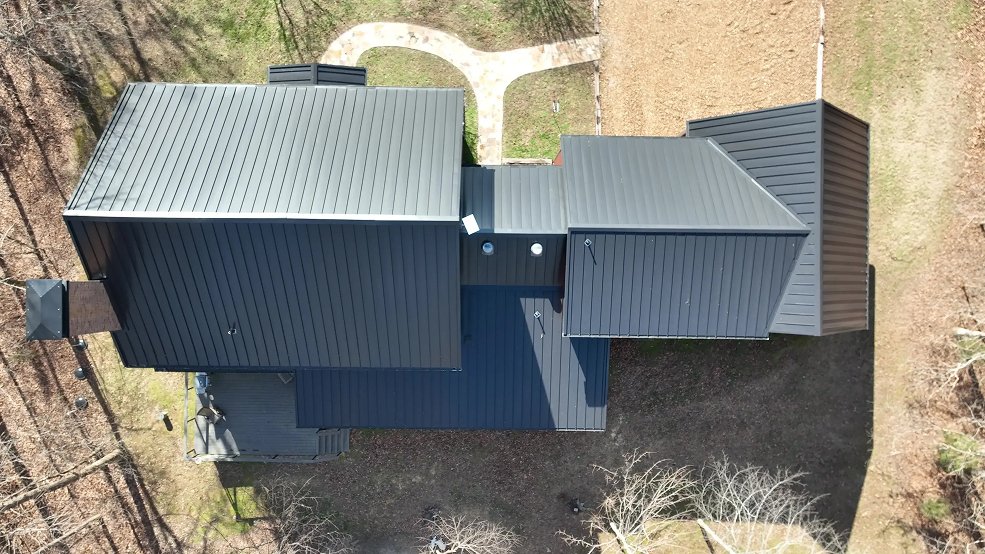 Dark bronze standing seam panel runs on a farmhouse roof in Columbia, TN