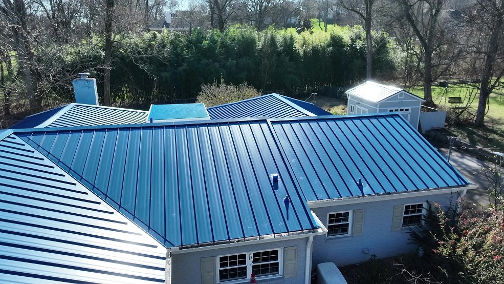 Royal blue standing seam metal roof on a mid century home in Nashville, Tennessee