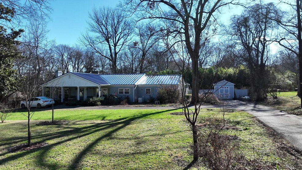 Royal blue standing seam panels on a mid century modern roofline in Nashville, TN