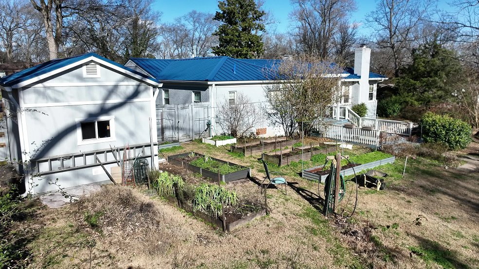 Royal blue standing seam metal roofing over a mid century entry in Nashville, Tennessee