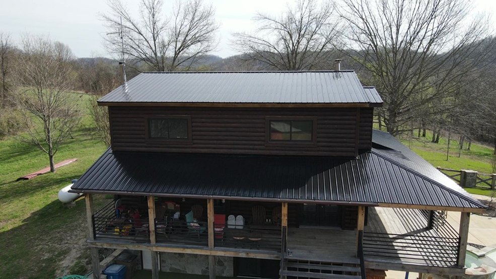 Black classic wave metal roof panels on a log cabin home in Sparta, TN