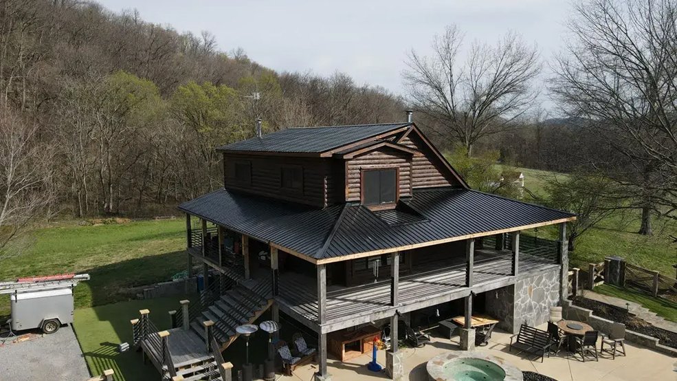 Black classic wave panel roof and gable on a log cabin in Sparta, Tennessee