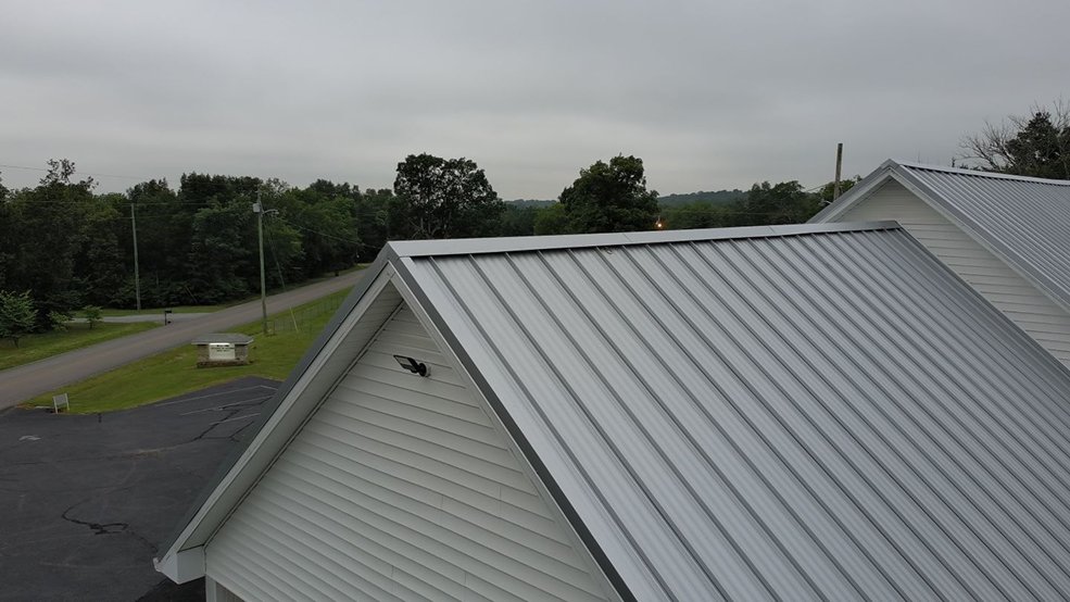 Silver standing seam metal roof and steeple on a church in Shelbyville, TN