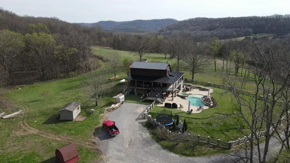 Black classic wave panel metal roof on a rural log cabin in Sparta, TN
