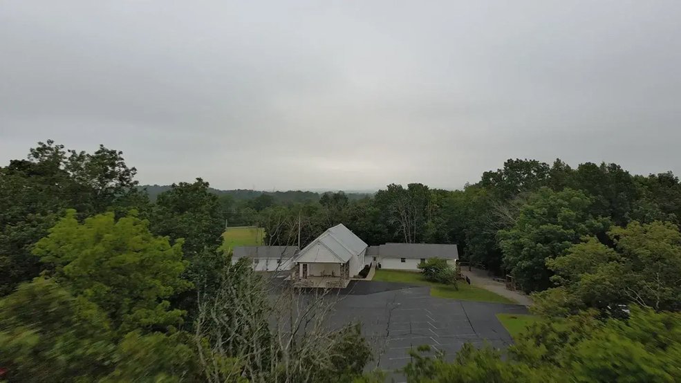 Silver standing seam metal roof over a church entrance in Shelbyville, TN