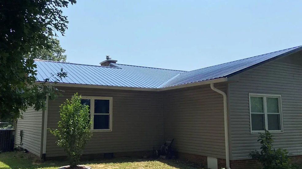 Black classic panel metal roof on a ranch home in open grassland near Smyrna, Tennessee