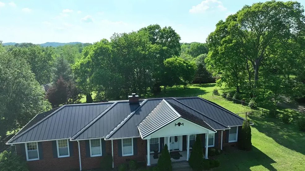 Black standing seam metal roof on a ranch home with a pool in Brentwood, Tennessee