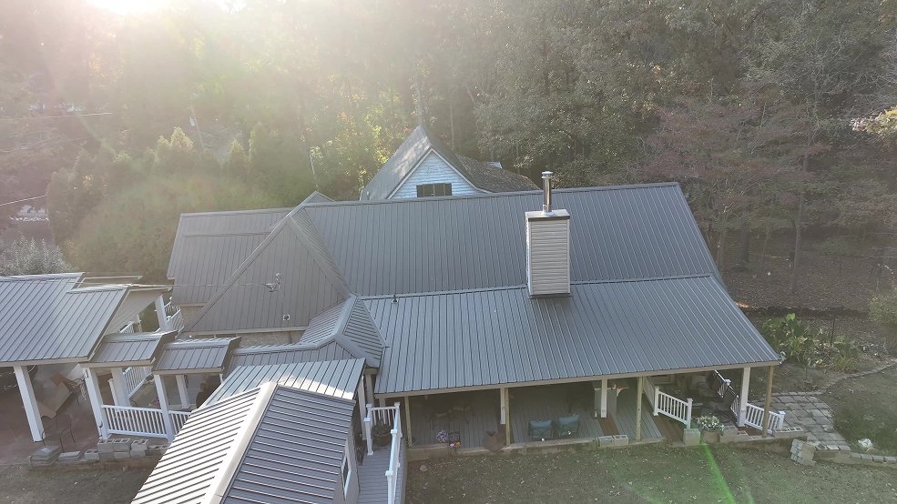 Gray standing seam metal roof above a rear deck in Nolensville, Tennessee