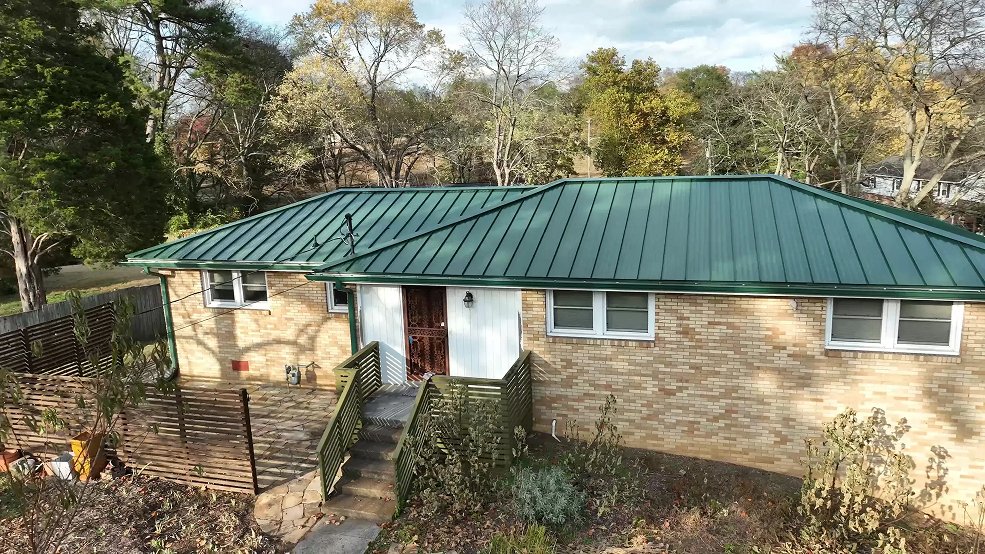 Green standing seam panels on a ranch home roof in Goodlettsville, TN