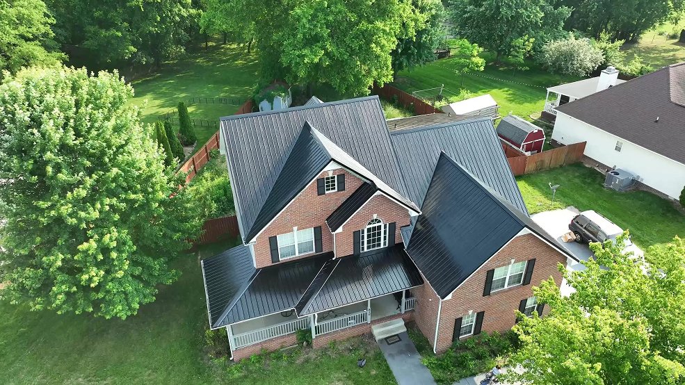 Full elevation of a black classic panel metal roof on a brick home in Hendersonville, TN