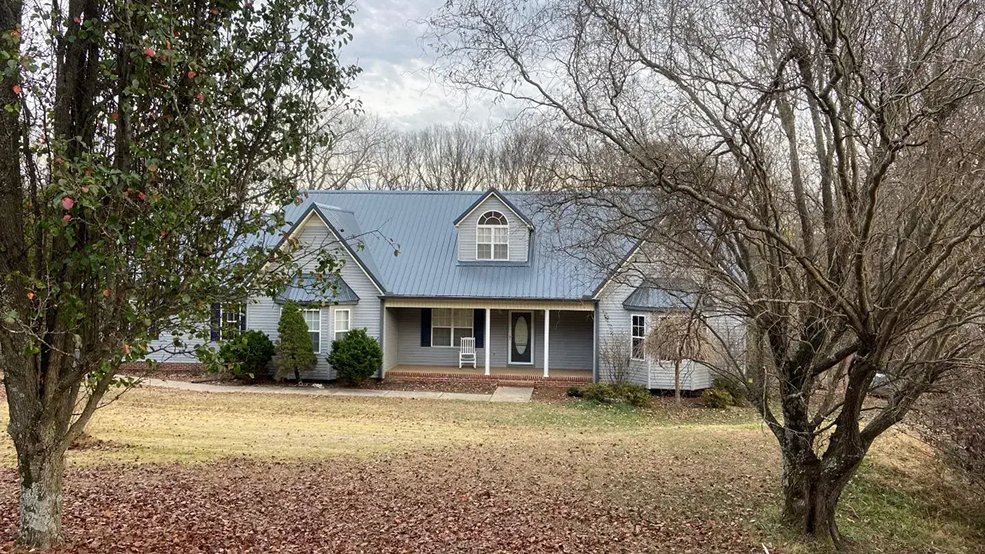 Gray standing seam metal roof over an outdoor deck in Nolensville, Tennessee