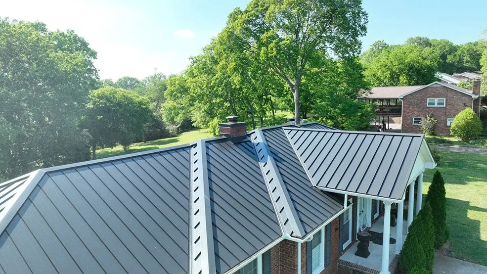 Black standing seam metal roof surrounded by trees in McMinnville, TN