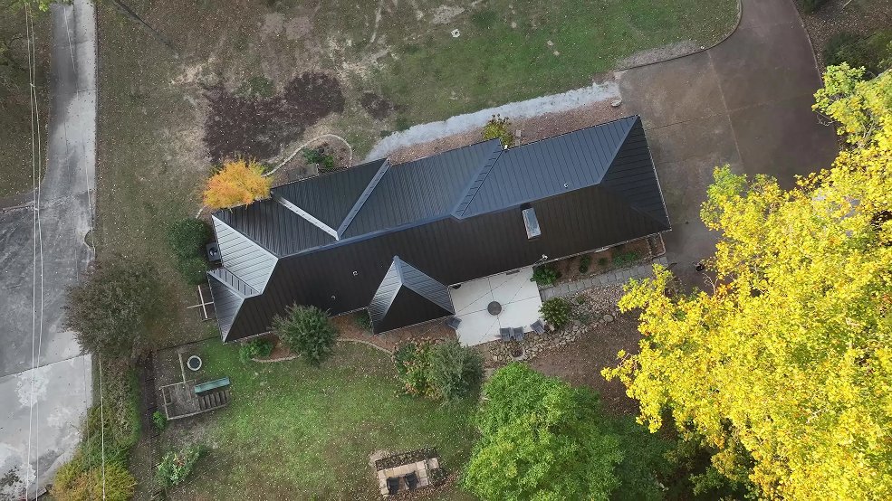 Black standing seam metal roof on a ranch home with pool in Brentwood, Tennessee