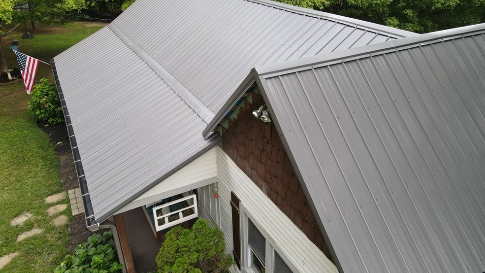 Black classic panel metal roof on a brick home in Hendersonville, Tennessee