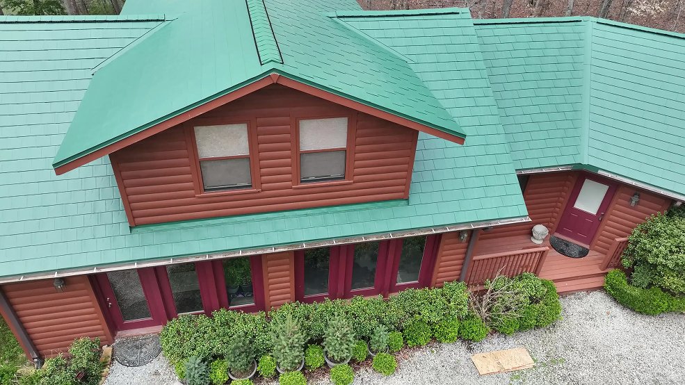 Green classic panel metal roof and treeline in Manchester, Tennessee